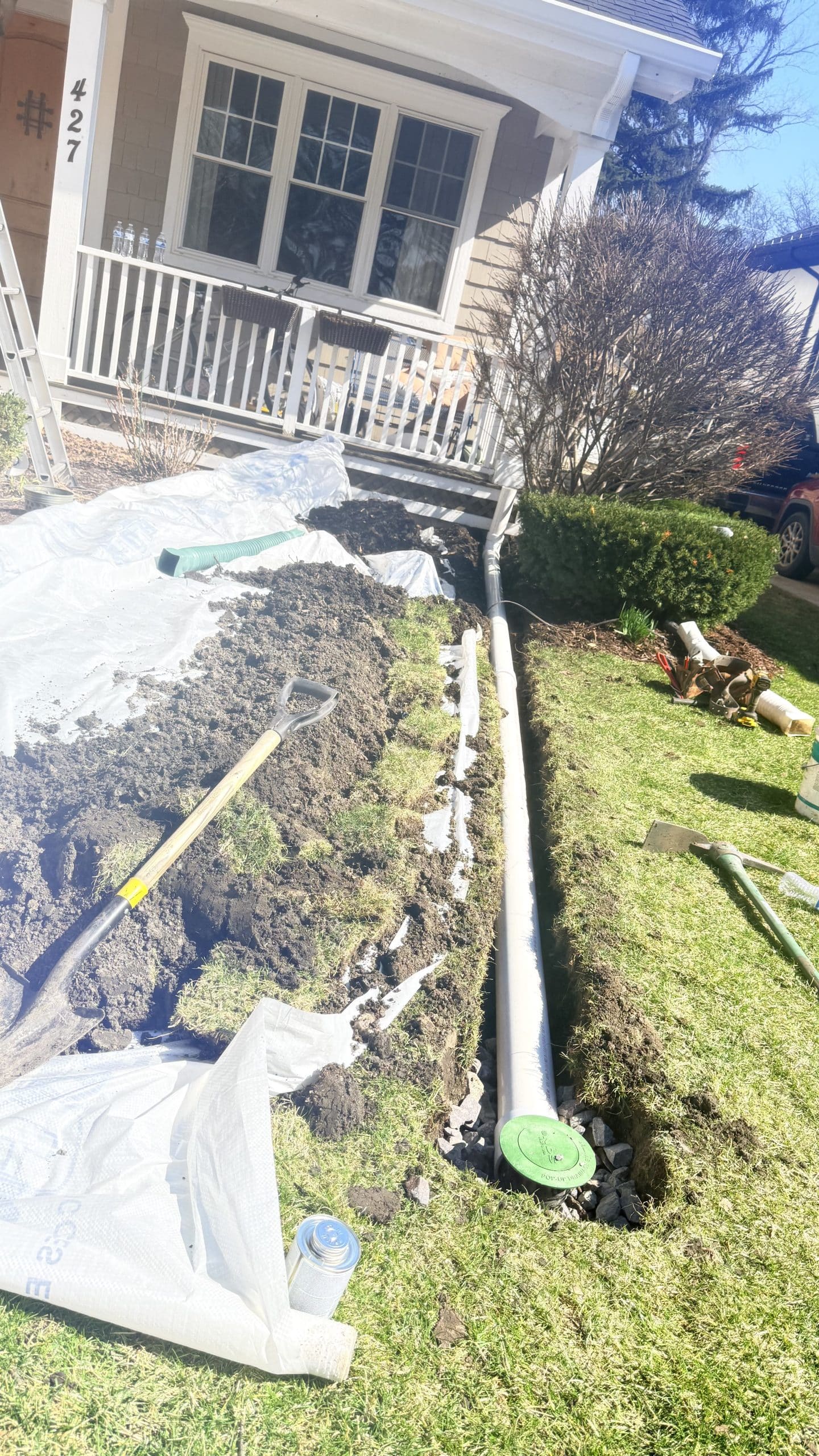 Underground downspout drain extension installation in Chicago redirecting water away from foundation